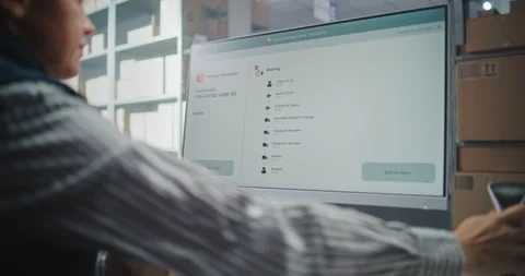 Female Postal Warehouse Associate Scanning Code, Checking Parcel Information on Stock Footage 307662626