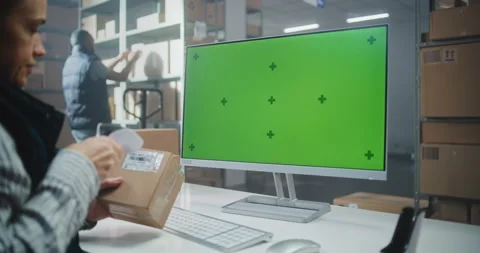 Female Postal Warehouse Worker Scans Code, Works on PC with Chroma Key Mockup Stock Footage 307662044