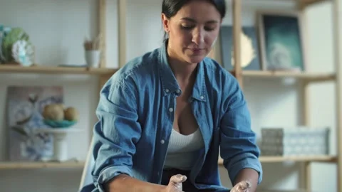 Female potter making ceramic pot on the twisted pottery wheel Video stock 233293944