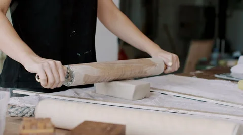 Female potter master cutting the round piece of clay on table. Stock Footage 66775241