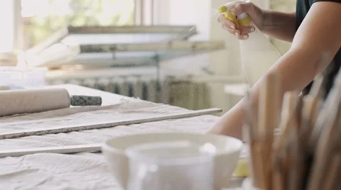 Female potter master preparing the clay on table. Video stock 66775307