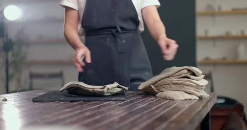 Female potter prepares the material for modeling ceramics. Woman hands shifts Stock Footage 155251676