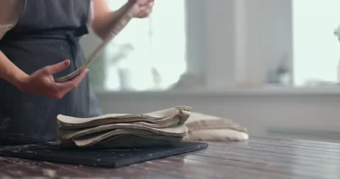 Female potter prepares the material for modeling ceramics. Woman hands shifts Stock Footage 155251711
