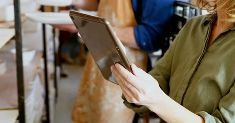 Female potter using digital tablet 4k Stock Footage 85327902