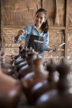 Female potter using digital tablet in pottery workshop Stock Photos
