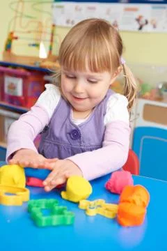 Female Pre School Pupil Playing With Modelling Clay Stock Photos