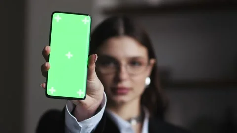 Female presenter displaying digital content on Chroma Key Greenscreen using Stock Footage 267609347