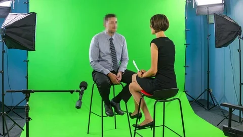 Female presenter interviewing man with pixelated and hidden face in tv studio Video stock 76203828