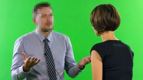Female presenter interviewing man with pixelated and hidden face in tv studio 스톡 동영상 76203906