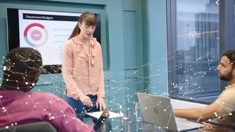 Female presenter referencing tablet during budgets meeting, driving node overlay Stock Footage 337579133