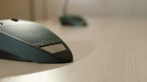 Female presses the button to speak desktop microphone in conference. Hand close Video stock 101971497