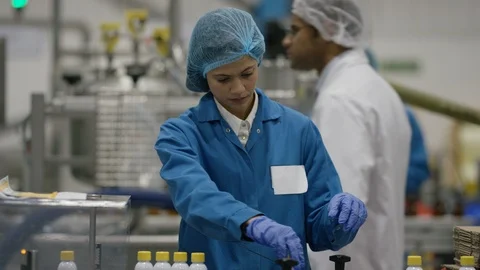 Female production worker smiling at camera while working at production line Stock Footage 107997138