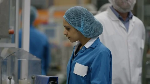 Female production worker smiling at camera while working at production line Stock Footage 107997583