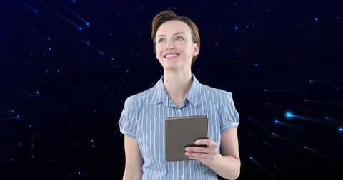 Female professional holding tablet in tech studio, showcasing starfield and Stock Footage 327782416