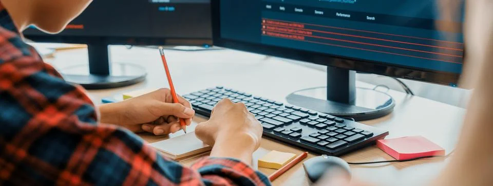 Female programer taking a note while web developer present program. Burgeoning. Stock Photos