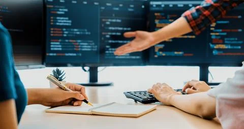 Female programer taking a note while web developer present program. Burgeoning. 스톡 사진