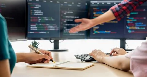 Female programer taking a note while web developer present program. Burgeoning. 스톡 사진