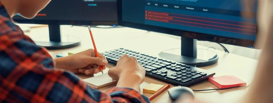 Female programer taking a note while web developer present program. Burgeoning. Stock Photos