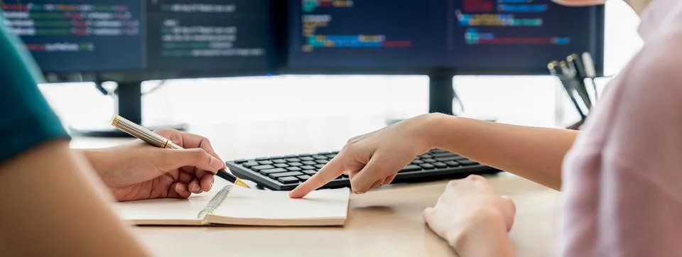 Female programer taking a note while web developer present program. Burgeoning. 스톡 사진