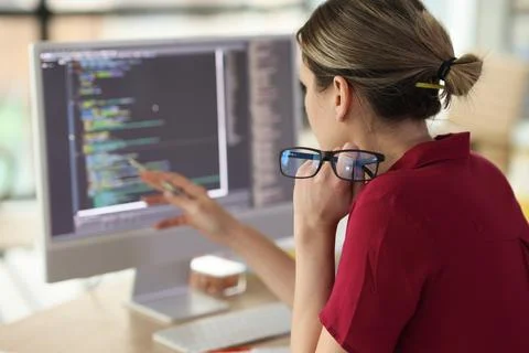 Female programmer checkups code working on computer Stock Photos