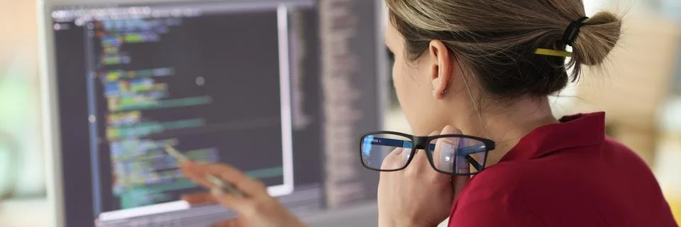 Female programmer checkups code working on computer 写真素材