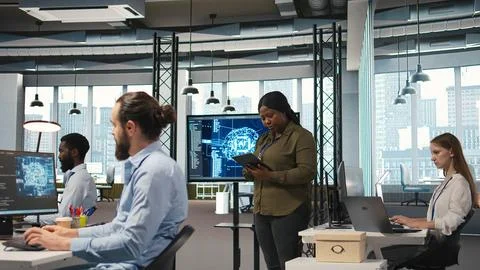 Female programmer coding AI algorithms on tablet to debug software issues Stockfoto's