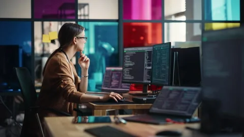 Female Programmer Coding Application In Office Stock Footage 223192537