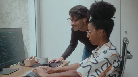Female Programmer Coding on Computer and Talking with Colleague Stock Footage 252750895