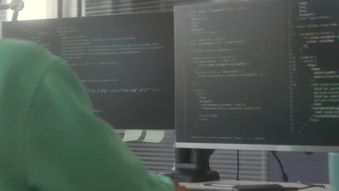 Female Programmer Coding on Computer with Multiple Monitors Stock Footage 263730657