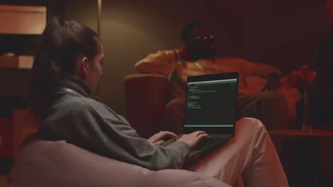Female Programmer Coding on Laptop at Night Office Stock Footage 259166071