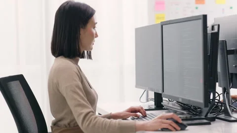 Female Programmer Coding on Multiple Screens. Stock Footage 267178702