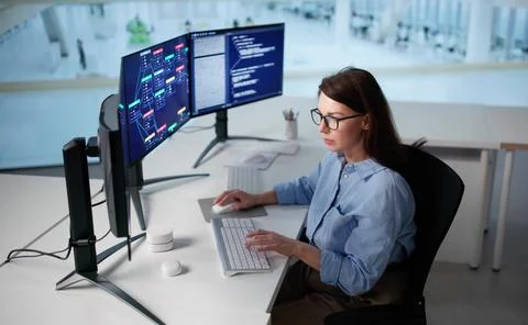 Female Programmer Collaborates With Team To Develop New Software Application. Stock Photos