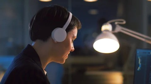 Female programmer with computer at night office Stock Footage 104195873