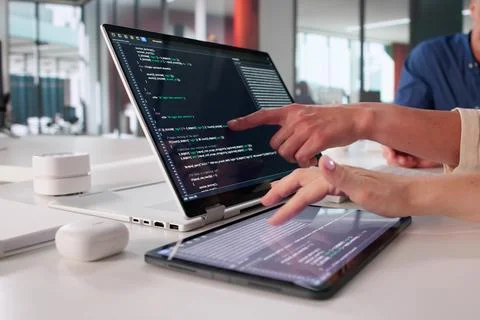 Female Programmer Creating Software Application With Team In Office Setting Stock Photos