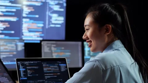 Female Programmer Database And Writing Code Laptop Using Multiple Monitors Stock Footage 244425812