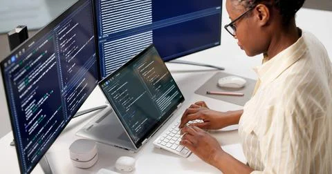 Female Programmer Developing Web Software On Computer At Office Desk 스톡 사진