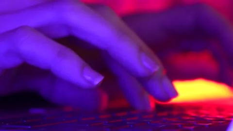 Female programmer, gamer or worker is using laptop keyboard on neon light, ni Stock Footage 172532644