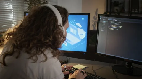 Female Programmer with Headphones Coding Cybersecurity System at Night Stock-Footage 348145484