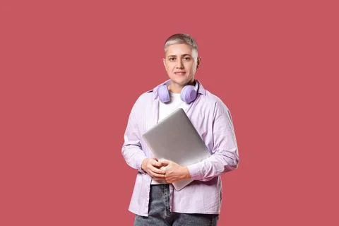 Female programmer with laptop on red background Stock Photos