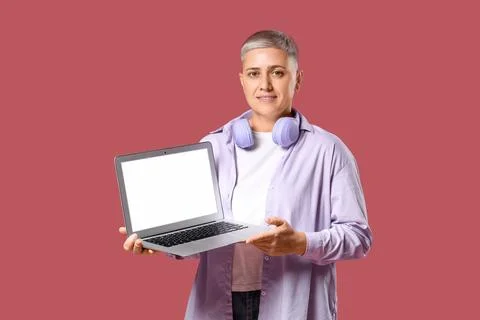 Female programmer with laptop on red background Stock Photos