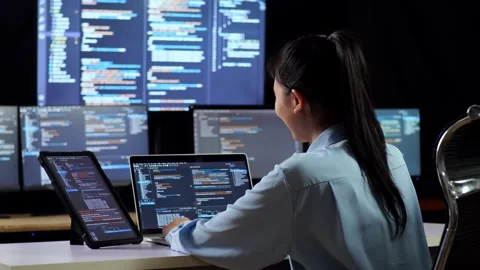 Female Programmer Look Database And Writing Code Laptop Using Multiple Monitors Stock Footage 244424457
