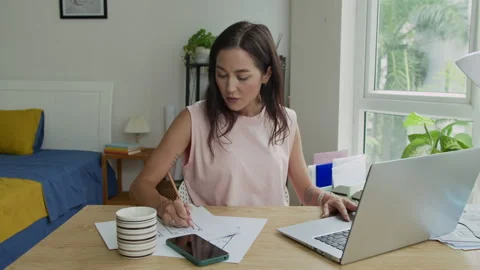 Female Programmer Multitasking during Work on Laptop at Home Office Stock Footage 300825659