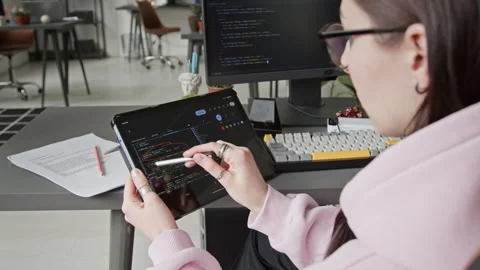 Female Programmer Reviewing Code from Vibe Coding Assistant on Tablet Video stock 335940673