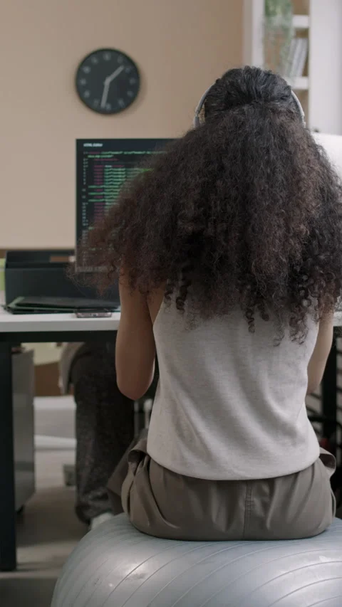 Female Programmer Sitting on Fit Ball at Office Desk and Coding on Laptop Stock Footage 274336807