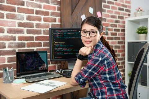 Female programmer sitting in working office Stockfoto's