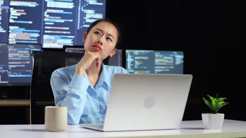 Female Programmer Something While Code By A Laptop Using Multiple Monitors Video stock 244421211