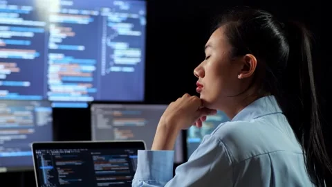 Female Programmer Something While Writing Code Laptop Using Multiple Monitors Stock Footage 244425895