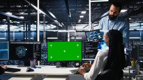 Female programmer talking with manager in AI data center, using mockup PC 스톡 사진