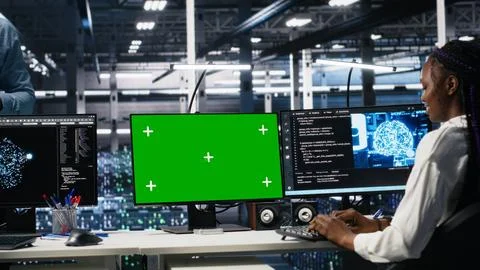 Female programmer talking with manager in AI data center, using mockup PC Foto stock