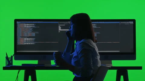 Female Programmer Talking on Phone and Coding on PC against Chroma Key Wall Stock Footage 268812119